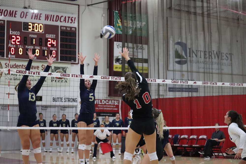 Bekah Boyle spikes the ball past Monterrey Bay's blockers. Photo credit: Mary Vogel
