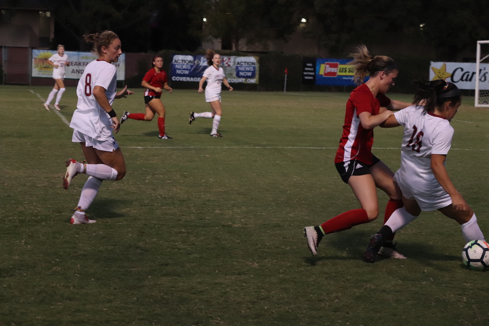 Alexi Vontsolos in defensive battle with Holy Names player. Photo credit: Melissa Herrera