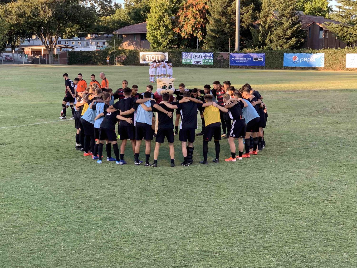 The Chico State men's soccer team huddled before their exhibition match against Holy Names University. Aug. 31, 2019 Photo credit: Lucero Del Rayo-Nava