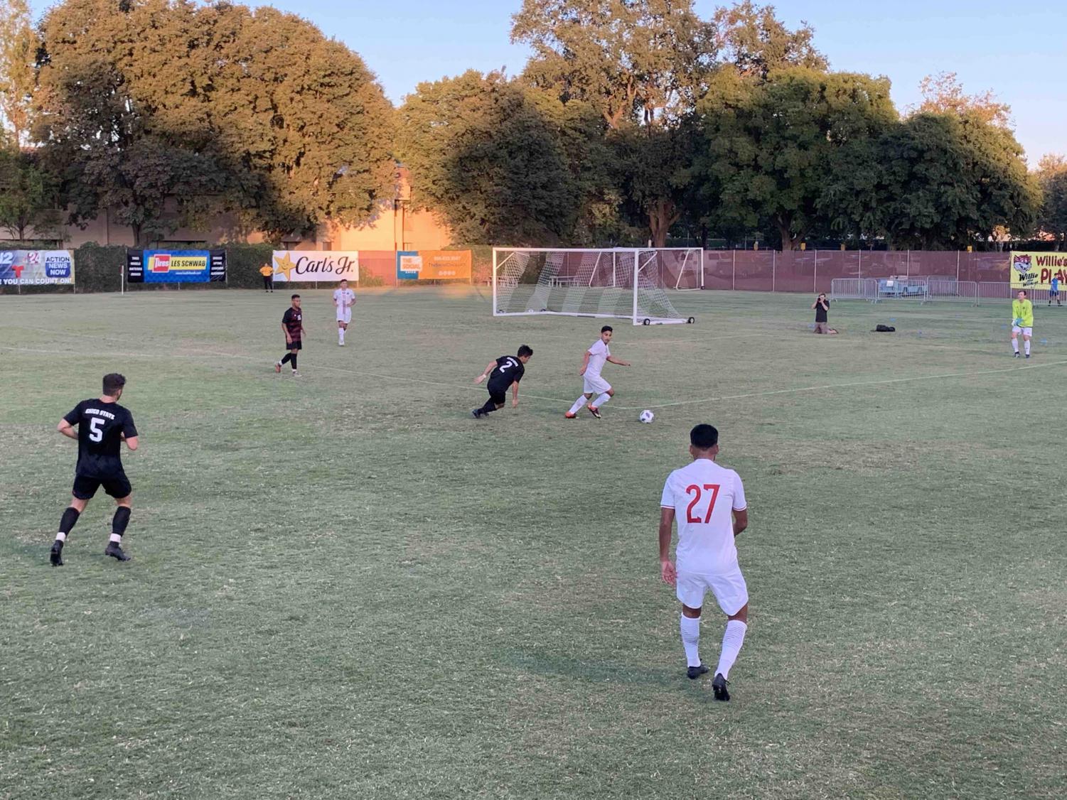 Mikey Hirsch running towards Holy Names player in exhibition match Saturday night. Photo credit: Lucero Del Rayo-Nava