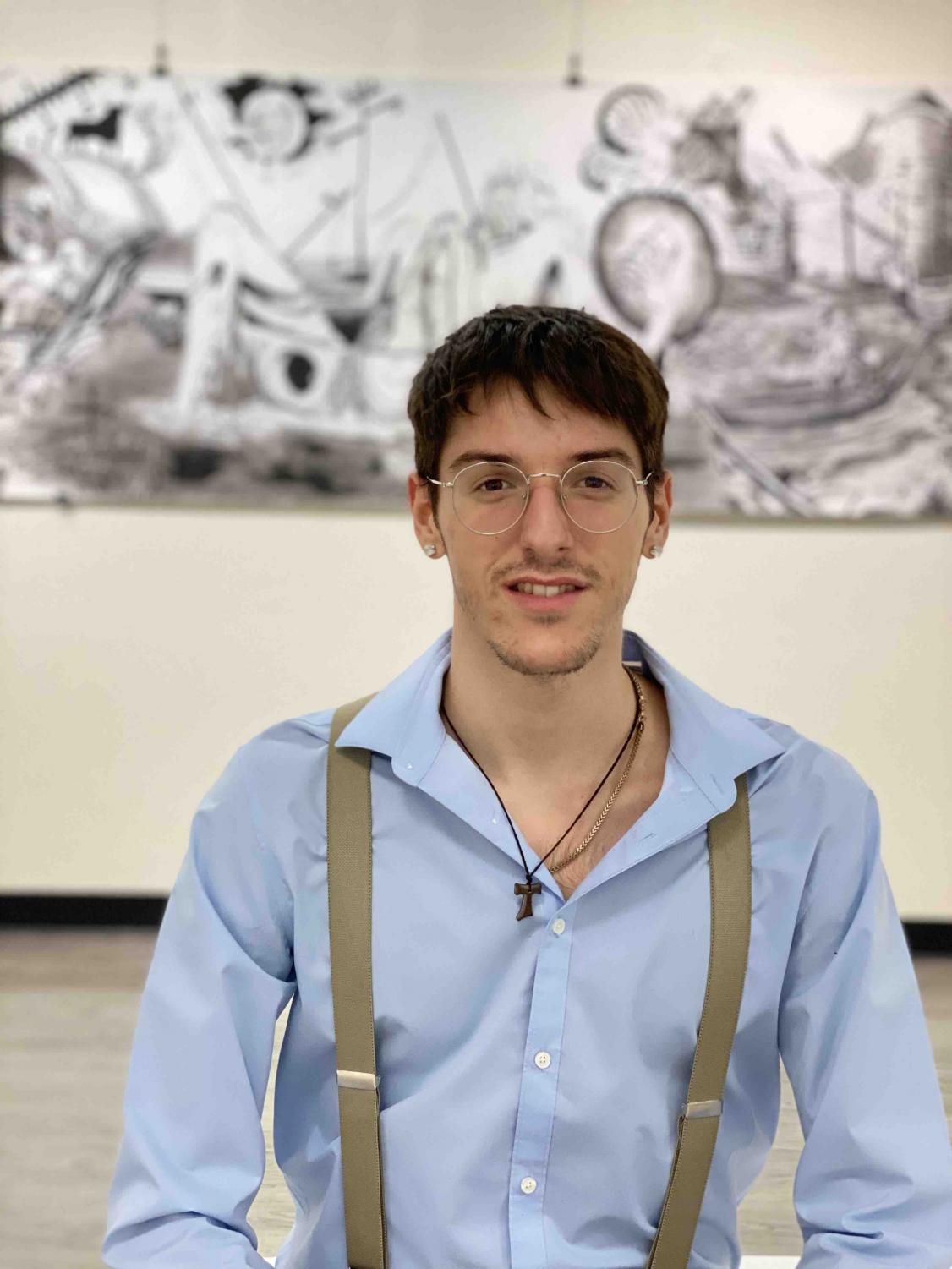 Rafael Orti Garcia stands in front of his piece entitled “Overwhelmed” Photo credit: Hana Beaty
