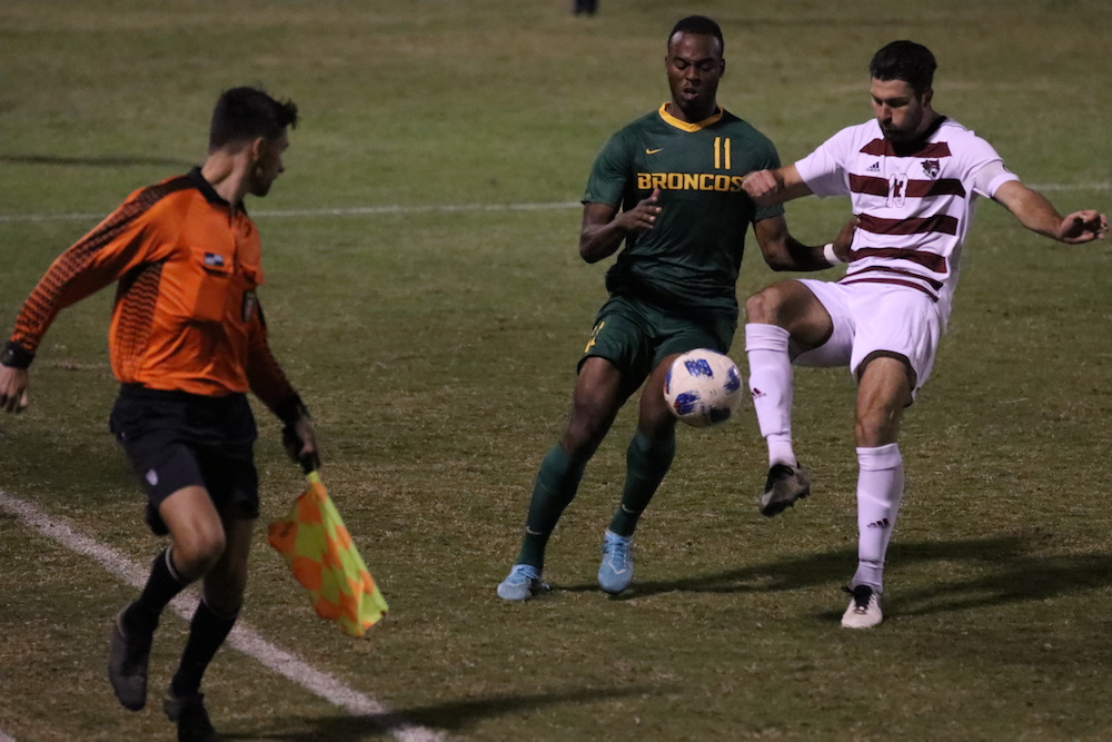 Jordan Jackmon and Garrett Hogbin went full sprint for the ball . Photo credit: Melissa Herrera
