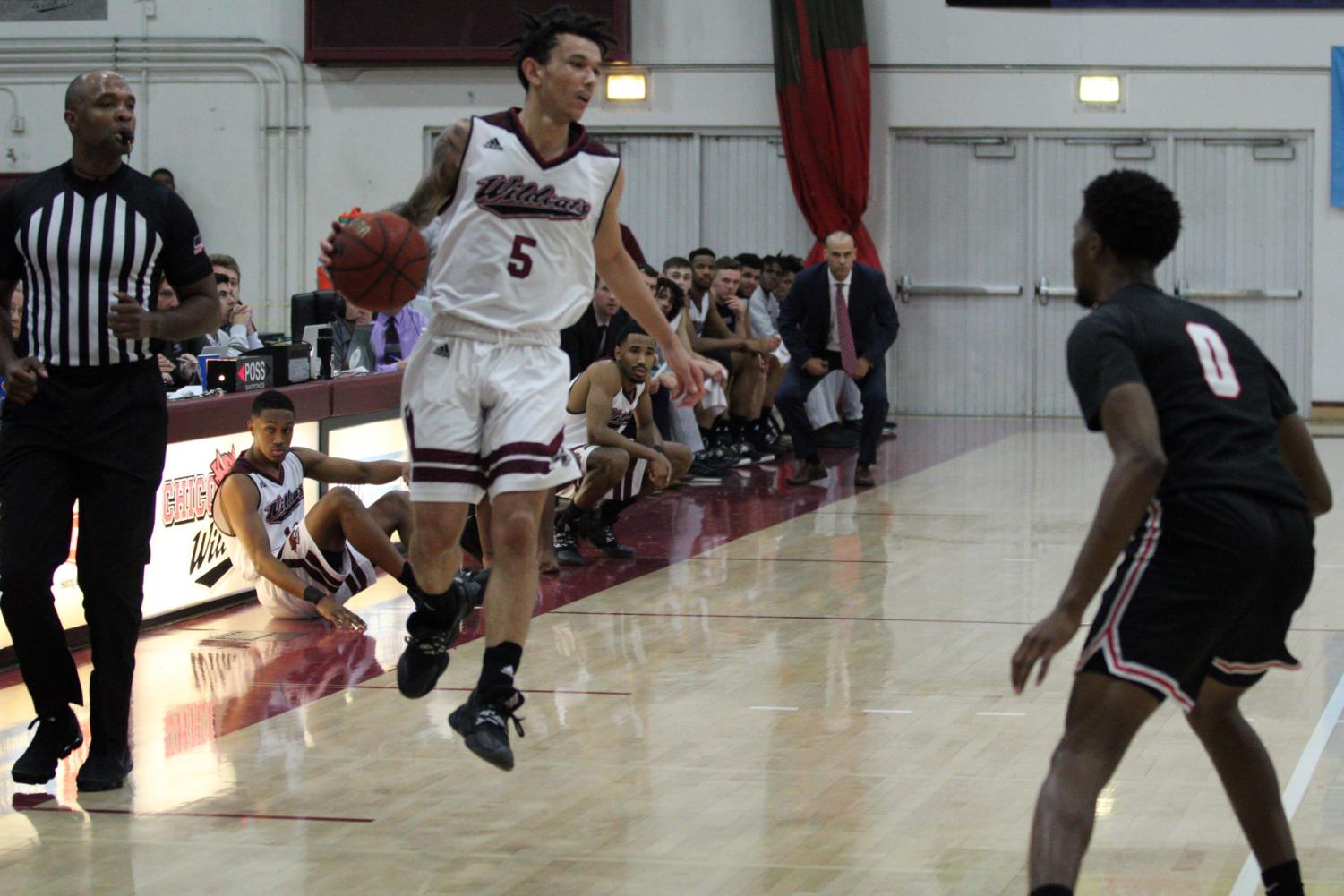 Isaiah Brooks brings the ball up the floor against Stanislaus State. Photo credit: Wesley Harris