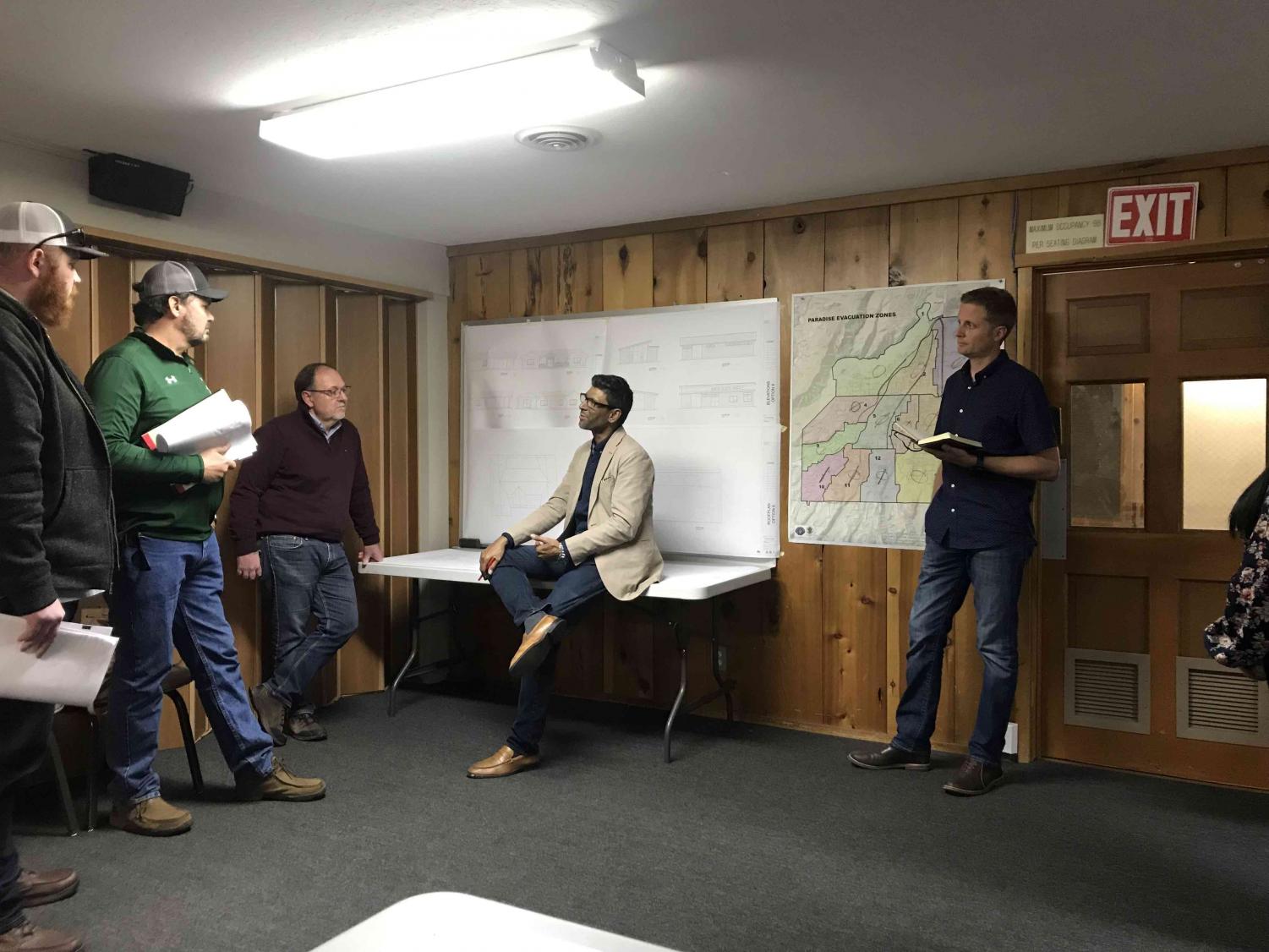 Professor Rouben Mohiudden talking with engineers and builders who will eventually start building homes from the student designed floor plans. Photo credit: Danielle Kessler