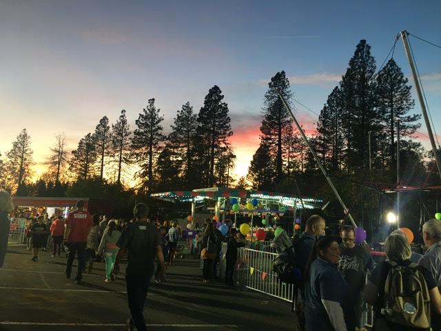 Fair goers enjoy games as the sun sets on Paradise. Photo credit: Melissa Joseph