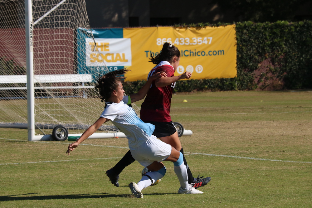 Sonoma player, Sam Layman, goes down and tries to take Chico player, Alexi Vontsolos, with her as well. Photo credit: Mary Vogel
