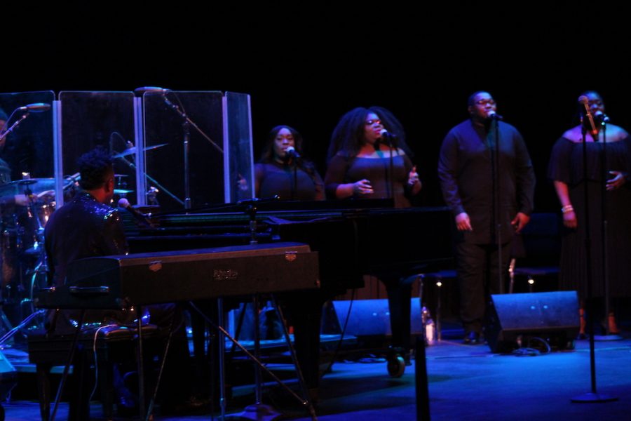 Damien Sneed performing with a choir
