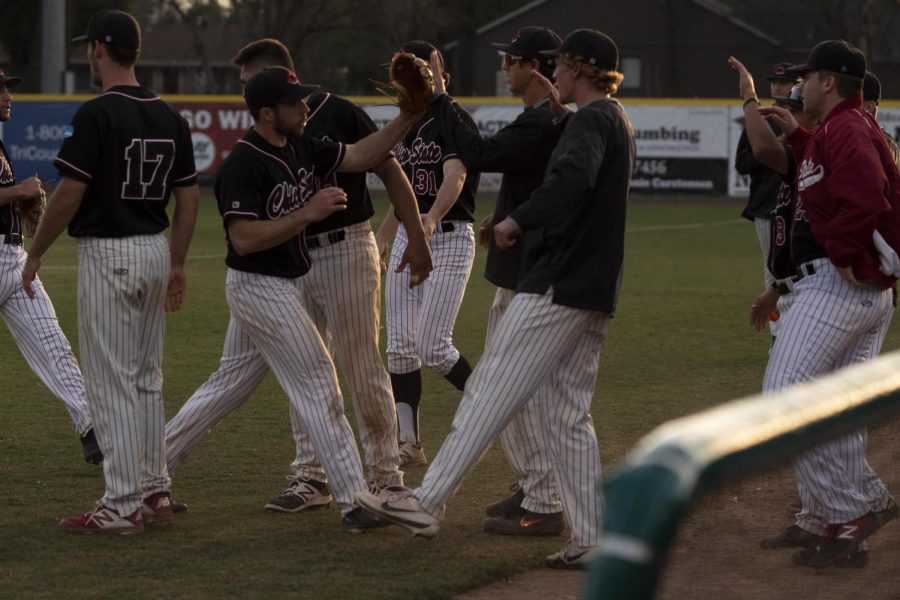 Daniel Foret praised by teammates after ending the inning.