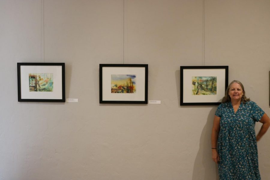 Kandis Horton-Jorth poses alongside her three pieces that will be available to view during the exhibit