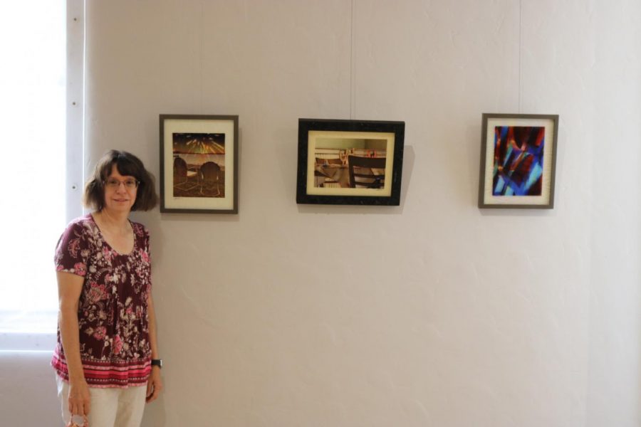 Penni Baxter stands with her work in the exhibit