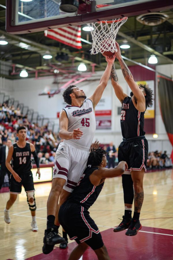 Chico State Wildcats #45 Malik Duffy (left) attempts to rebound against Cal State Stanislaus Warriors #22 Xavier Francois (right) in the first half of their CCAA Mens Basketball Tournament on Tuesday, March 3, 2020 in Chico, CA. (Jason Halley/University Photographer/CSU, Chico)