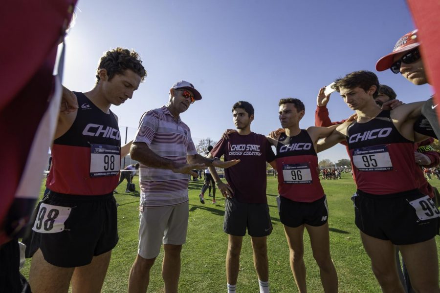 Coach Gary Towne (second from left) talks to the Chico State Wildcats before they compete in the men's 2019 NCAA Division II Cross Country Championships at Haggin Oaks Golf Course on Saturday, November 23, 2019 in Sacramento, Calif.