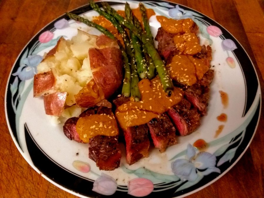 Medium-rare+grilled+New+York+strip+steak+with+mole%2C+asparagus+and+baked+potato%2C+topped+with+toasted+sesame+seed.