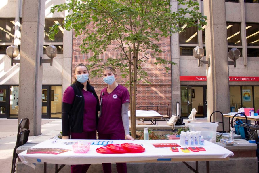 Nursing students, Ireland Vallejo (left side) and Katrina Tully (right side) giving out free swag to people who received flu shots on Oct. 14, 2021.