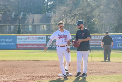 Infielder, Jacob Jablonski walking towards the dugout to get his glove and hat at the end of the inning.