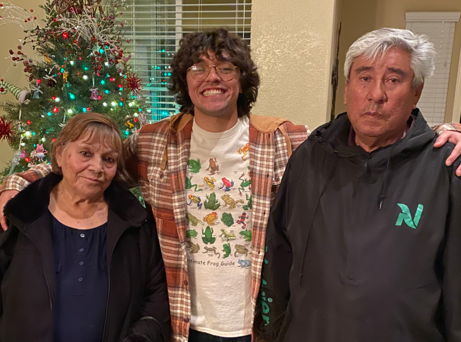 Mario Ortiz posing with his grandmother Simona Ortiz (left) and his grandfather Ubaldo Ortiz (right) on Christmas.