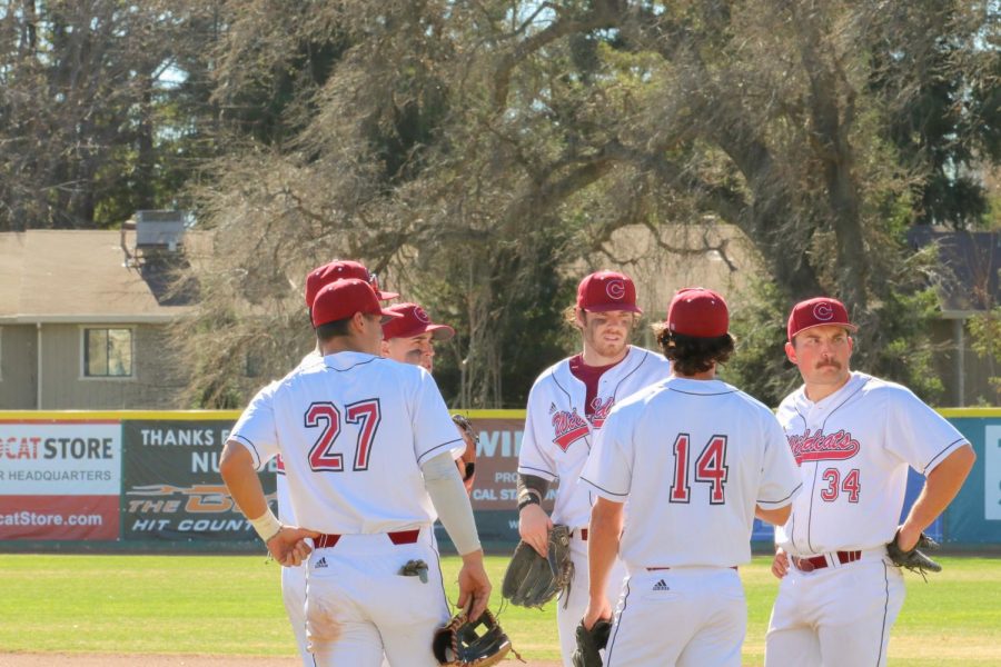 Before taking the field, a group of fielders are talking before the start of the game. The Wildcats played Simpson University Red Hawks on Feb. 16, 2022. at Nettleton Stadium, defeating the Red Hawks 14-5.