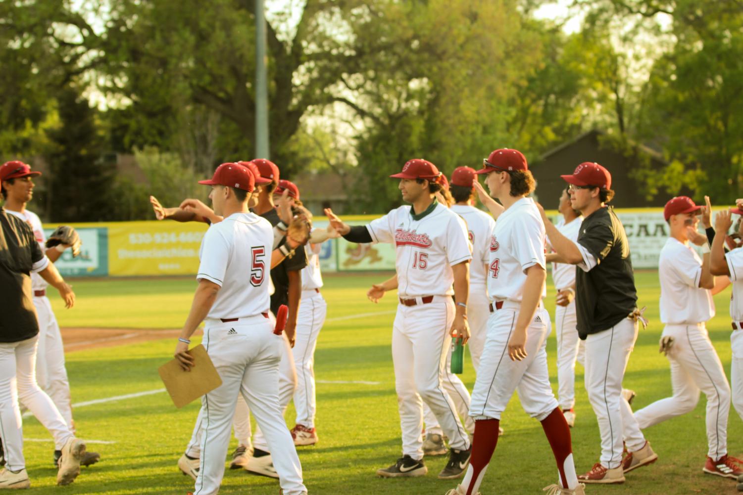 After the top on the second inning being completed, a group of Wildcat baseball players show their support to the fielders on getting out of the inning.