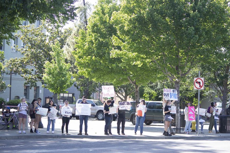Gender Sexuality & Equality Coalition members protesting before the crowd arrives at Chico City Plaza on May 3, 2022.