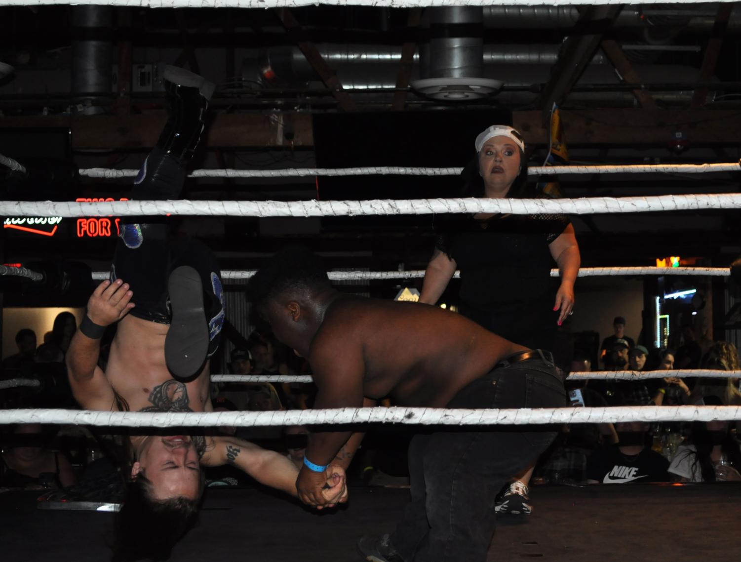 25 Cent flipping Dylan Michaels, and Tiffany Payne (referee). Photo taken by Mario Ortiz on June 17.