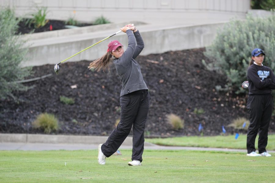 At the top of the tee box, Taylor Stewart hits her golf shot into the fairway with her driver. Walking towards her golf shot, junior Taylor Stewart looks to be in good spirits. Photo captured by Chico State Sports Information.
