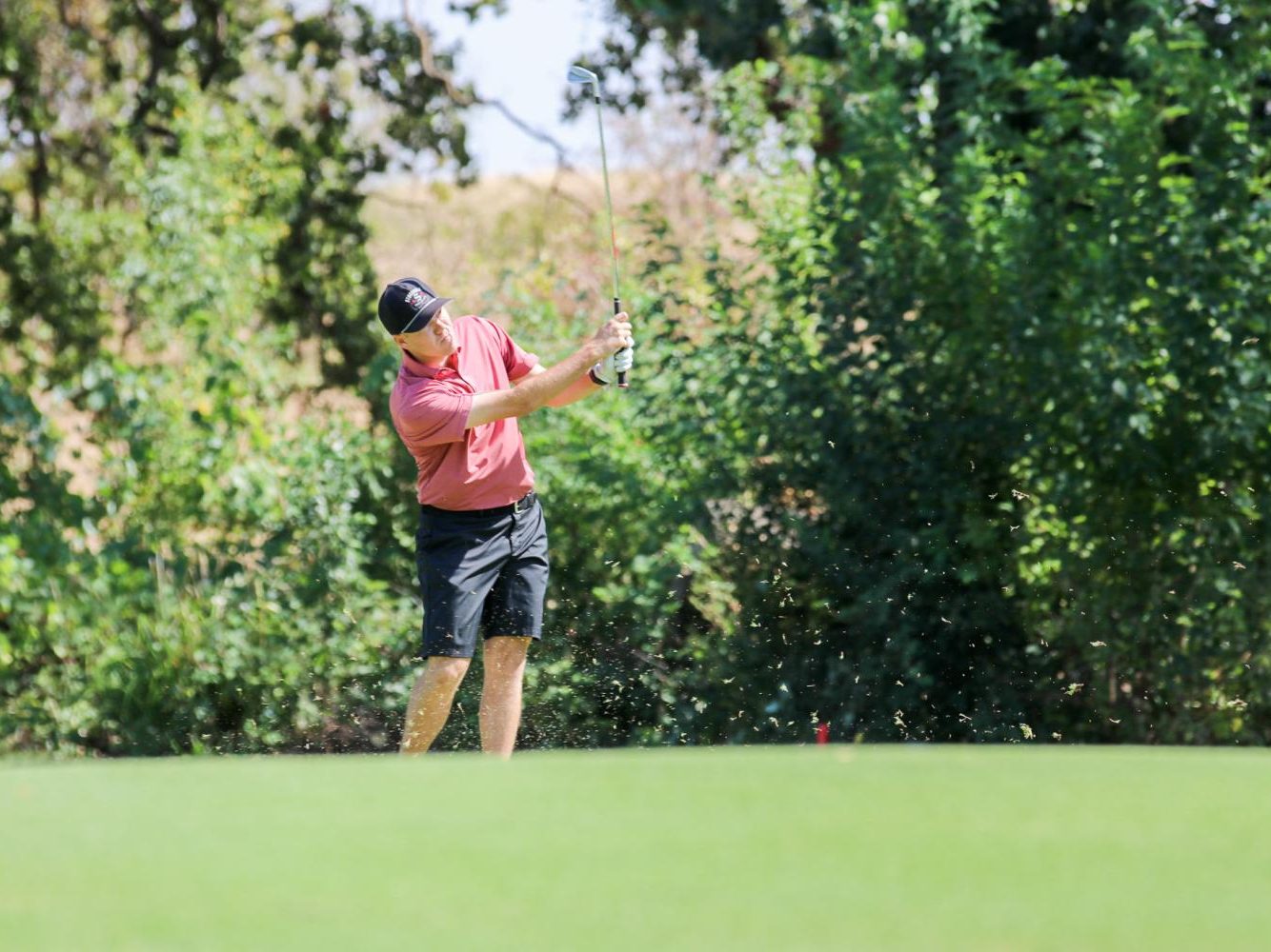 At practice, sophomore Dakota Ochoa hits his golf ball down the middle of the fairway with one of his iron clubs. Photo captured by Alejandro Mejia Mejia