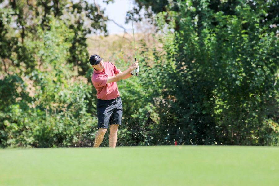 At practice, sophomore Dakota Ochoa hits his golf ball down the middle of the fairway with one of his iron clubs. Photo captured by Alejandro Mejia Mejia