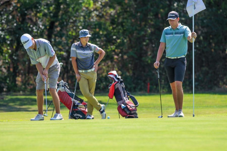 Pictured from left to right, sophomore Brayden Russo, and freshmen Giuliano Kaminski and Landon Williams wait for Russo to hole his golf ball. Photo captured by Alejandro Mejia Mejia