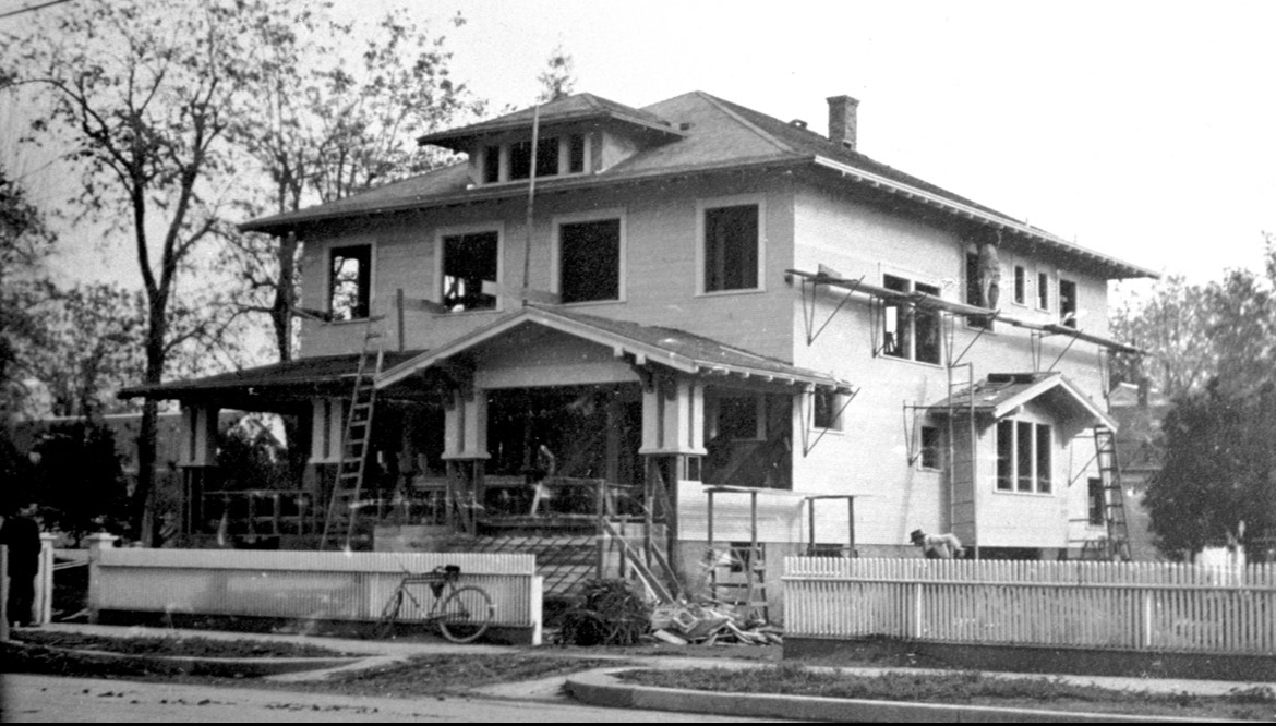Black and white photo of house being built
