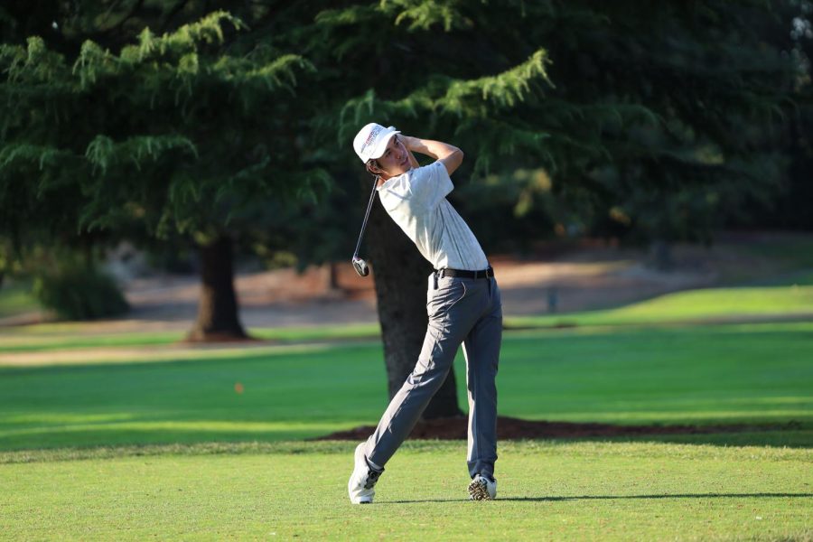 During the Western Washington Invitational, freshman Naoki Easterday hits a golf shot with hit iron. This was his first invitational for Chico State. Photo Credit: Jeff Evans/Western Washington University