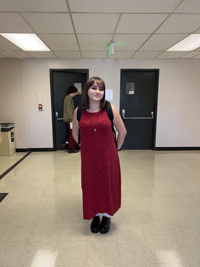 Student in hall wearing long red dress