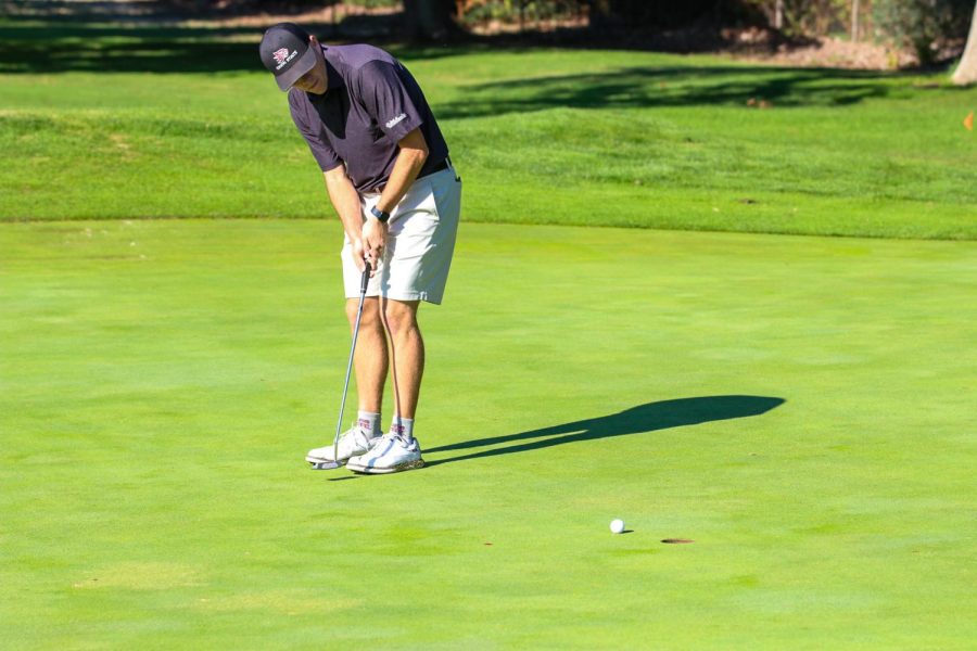 At the Peach Tree Golf and Country Club in Marysville, sophomore Dakota Ochoa sinks his putt for the birdie at hole six.
