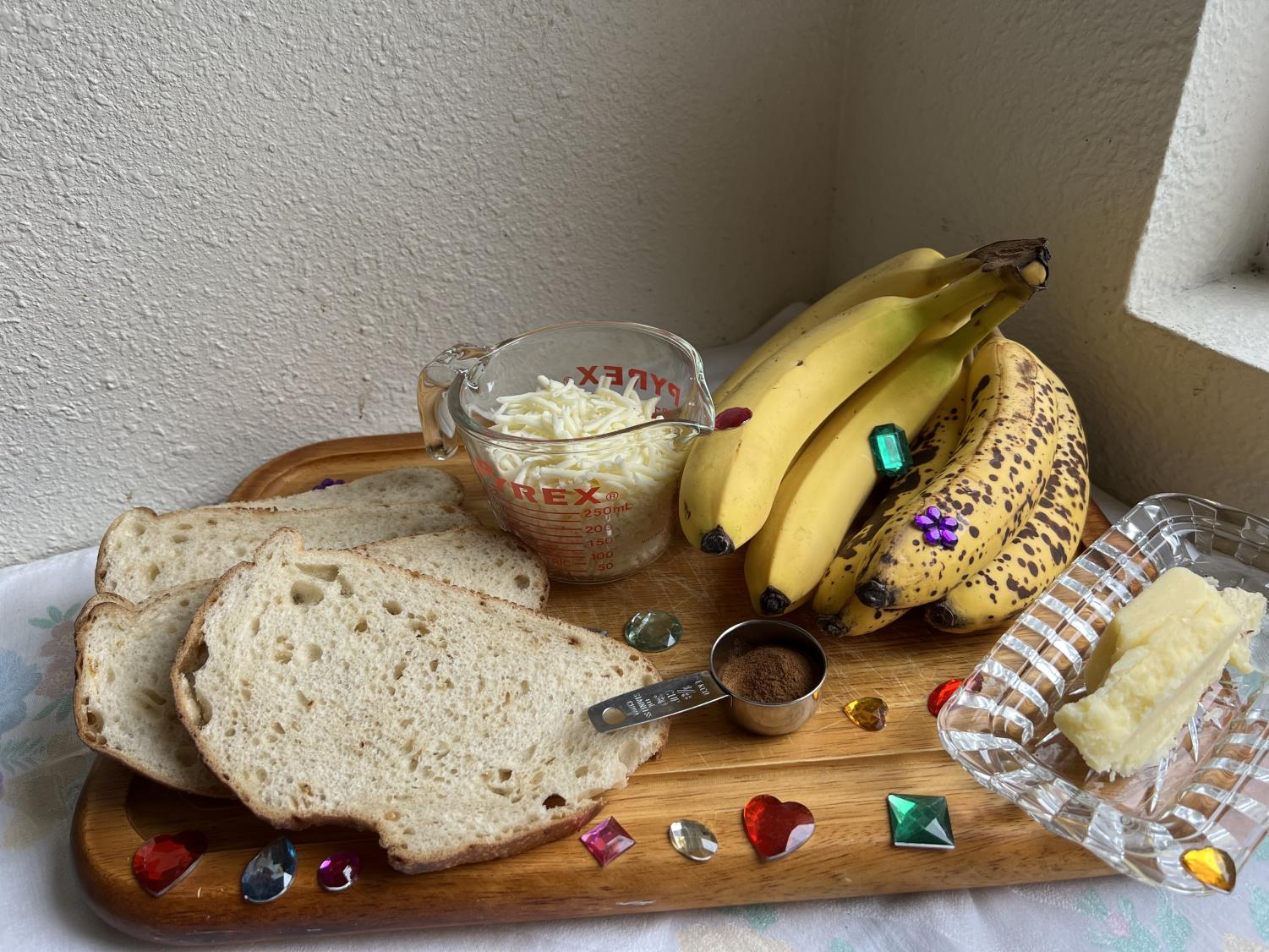 bananas mozzarella bread butter and cinnamon on cutting board with colorful gems
