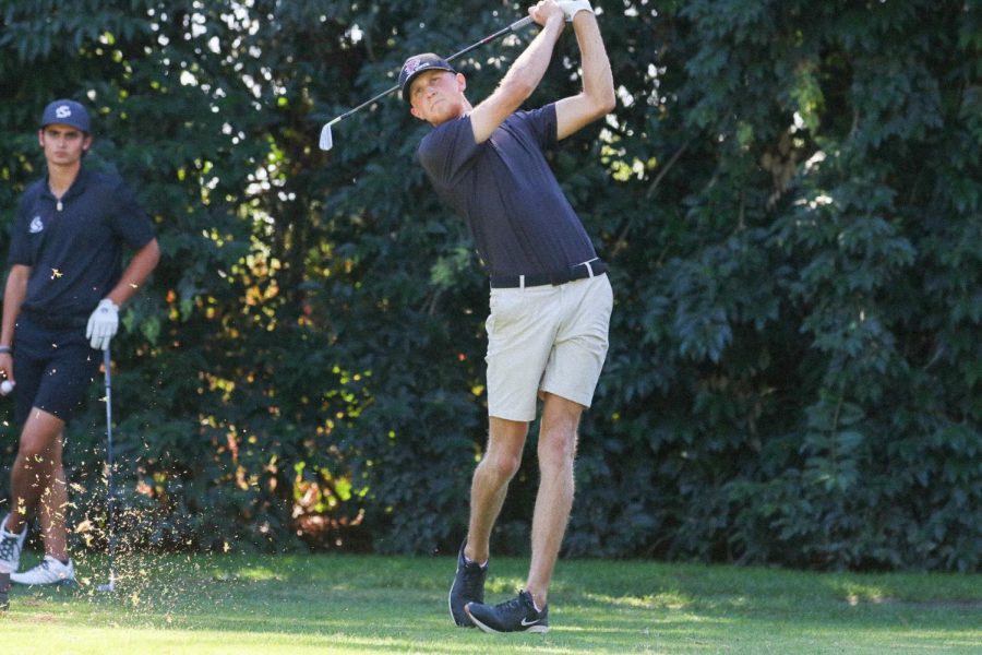 On Oct. 10, junior Tayler Ashman looks to aim his shot onto the green with an iron club at the Peach Tree Golf and Country Club. Ashman, went 8 under-par during the Wildcat Classic and finished in sixth place.