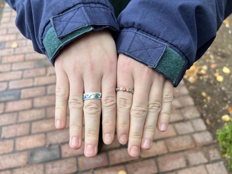 cute pale hands with two metal rings