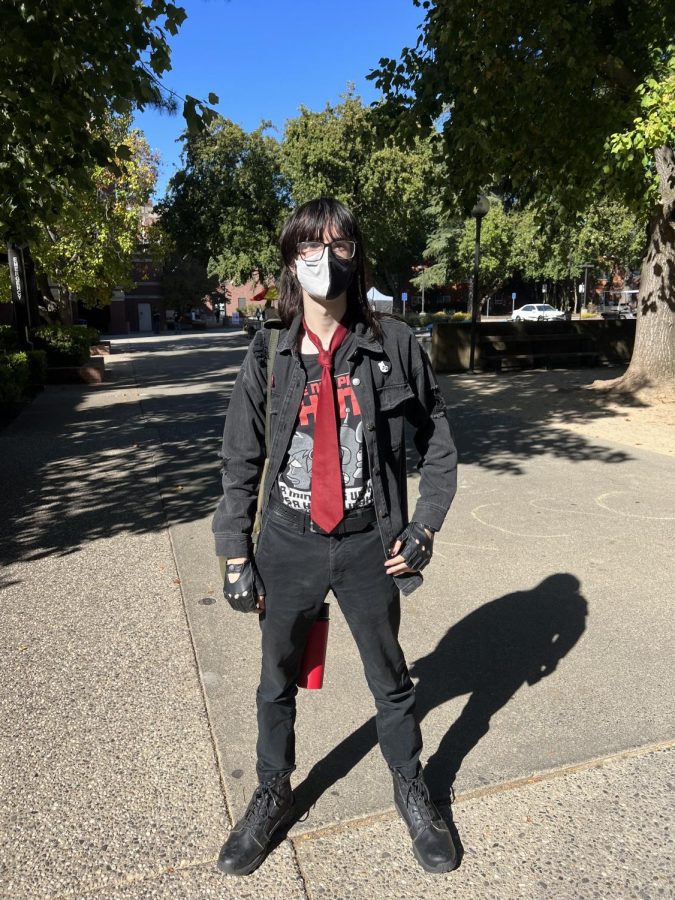 Milo Bruschke wearing a dark fashionable outfit