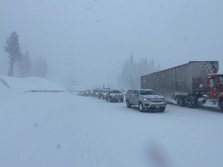 cars at stand still on highway in blizzard conditions