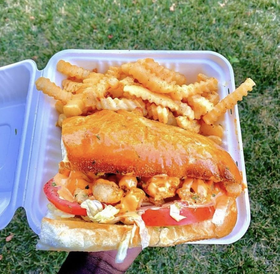 Shrimp sandwich served with fries on the side. 