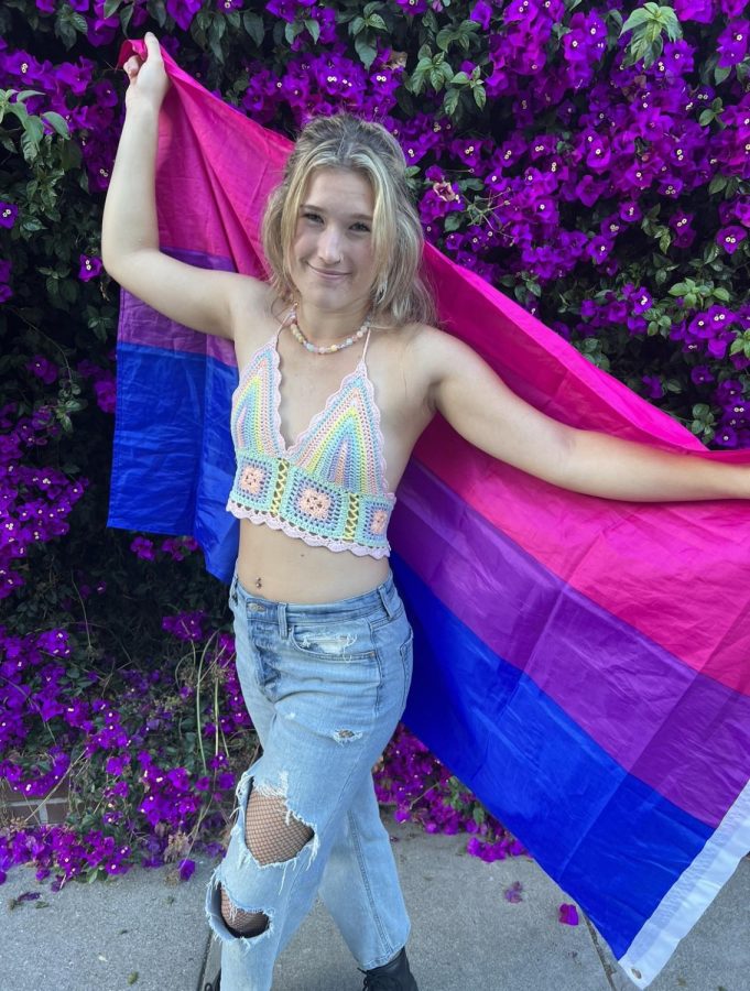 Hunter holding a bisexual flag. 
