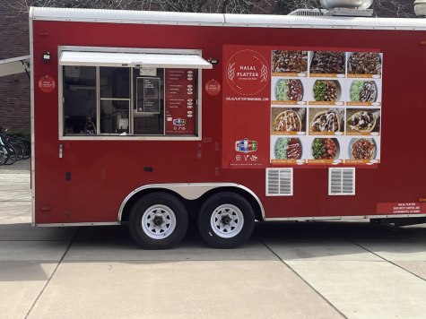 The bright red Halal Platter food truck sits in the Student Services Center Plaza.