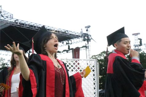 Shae Pastrana yelling to family before she walks the graduation stage. Melvin Bui right. Photo taken May 18 by Molly Myers.
