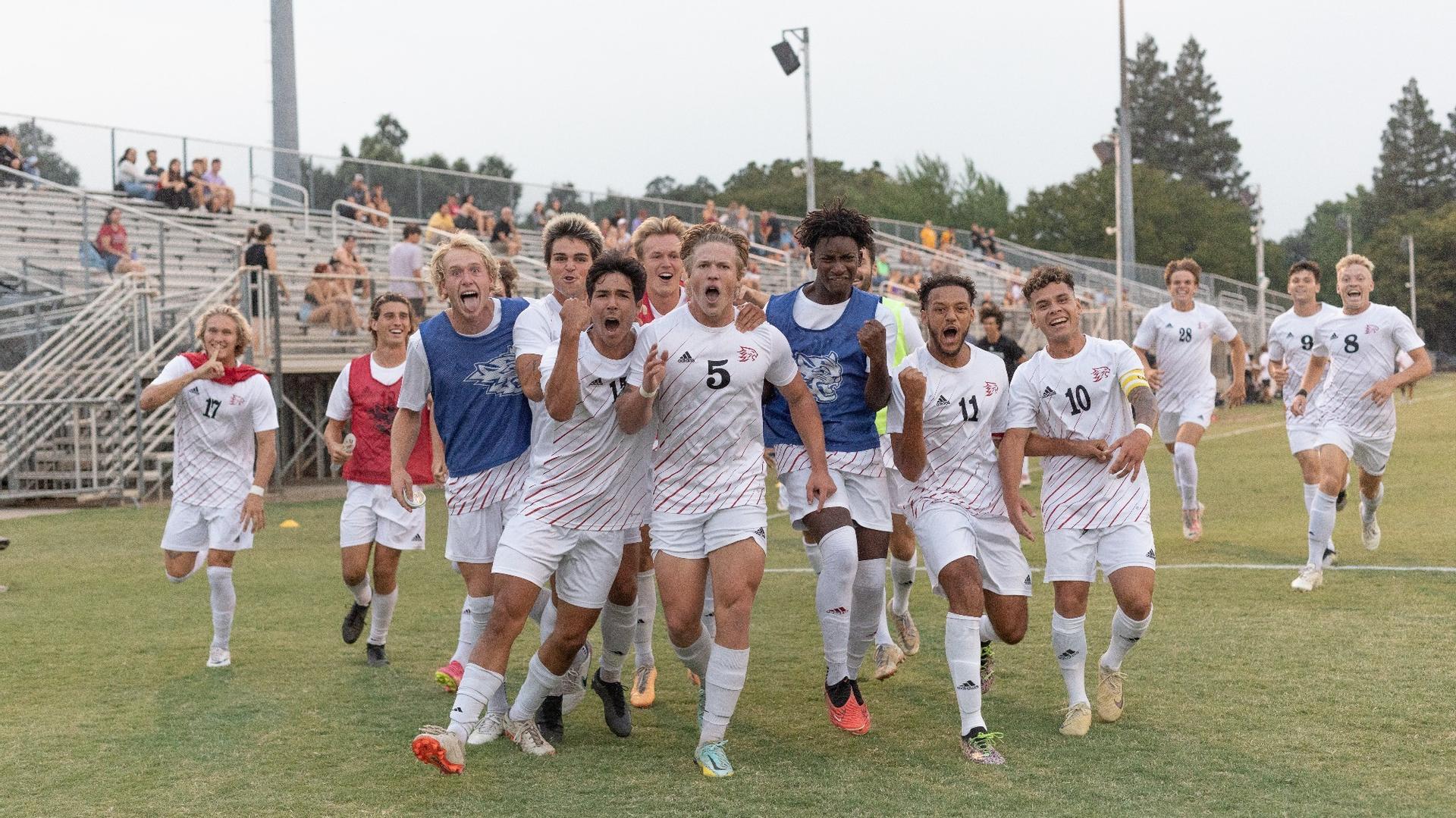 The Wildcats celebrate after Miles Rice (front center) scores a goal.