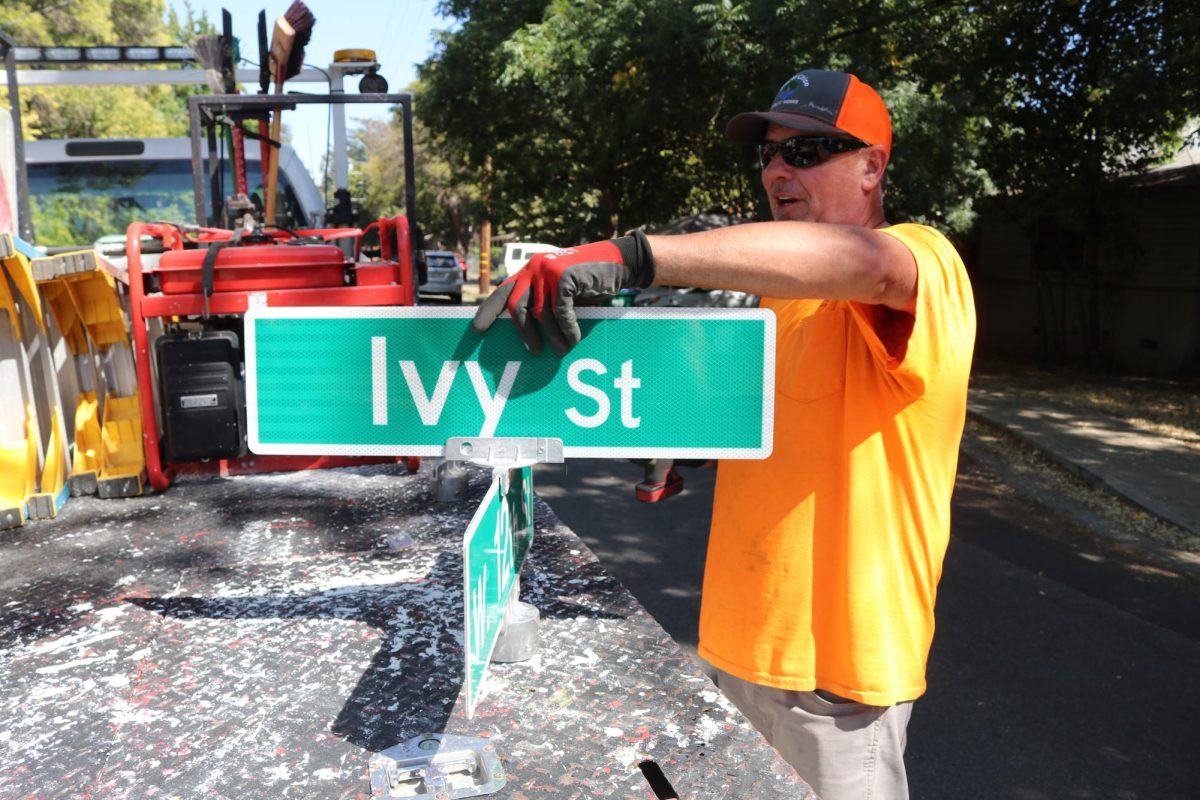 Eric Penrod, senior maintenance worker for the City of Chico, with two fresh street signs ready to replace a stolen set. Photo taken Sept. 14 by Molly Myers. 