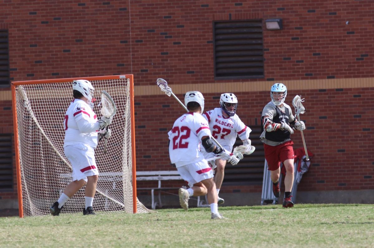 Members of Chico State’s Men’s Lacrosse team defending their goal during their alumni game on Oct. 14.