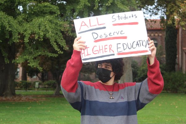 Butte College student, Augustus Chamberlain, holds up a sign during Wednesday’s student protest. Taken by Ariana Powell on Nov. 15.