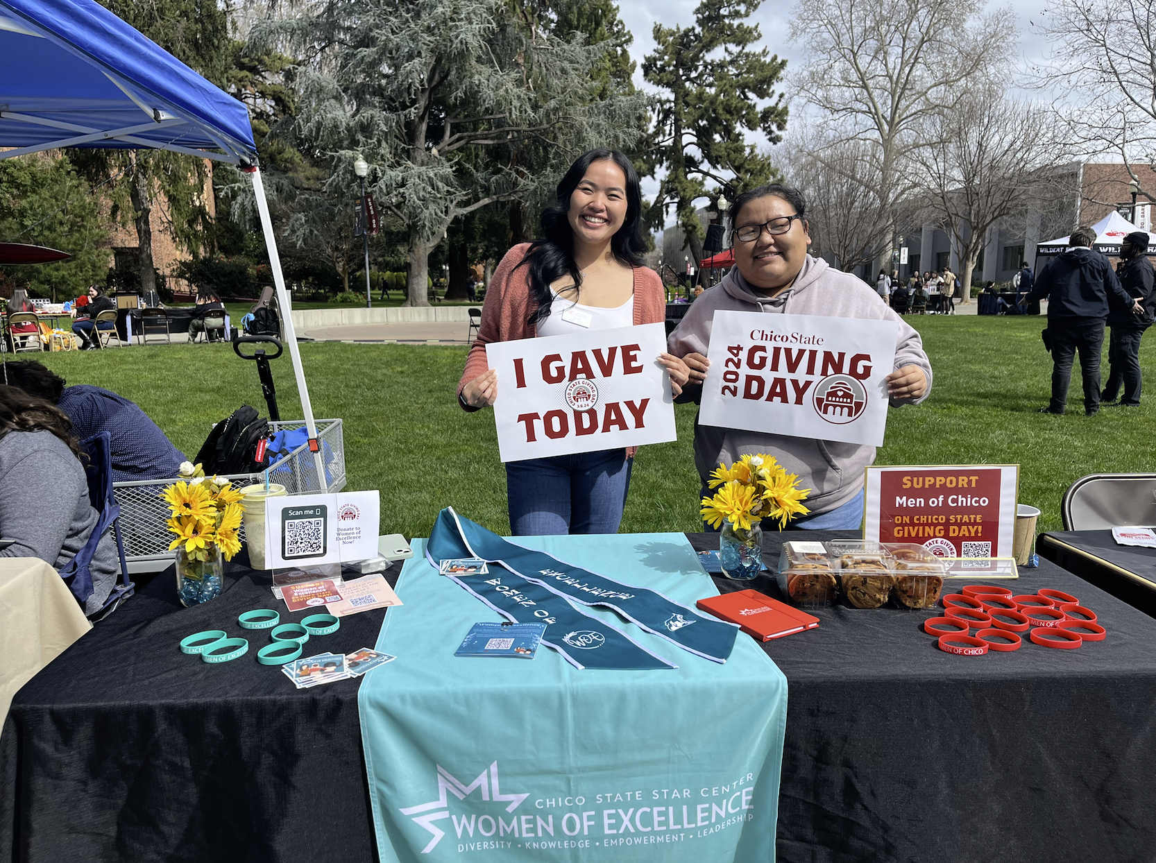 Two people table for the Women for Excellence program at the Giving Day Fair. Taken by Ariana Powell on March 6, 2024.