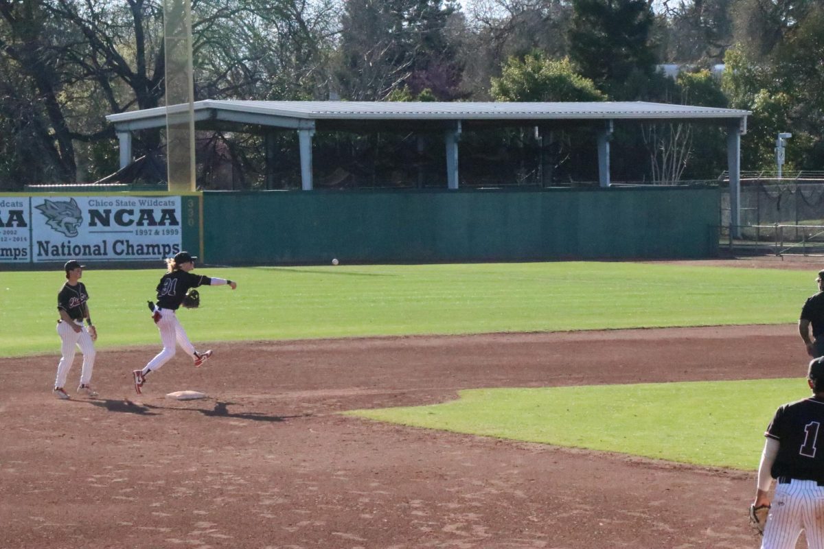 Sophomore+shortstop+Lorenzo+Mariani%2C+right%2C+making+a+tough+throw+on+a+ground+ball+up+the+middle+against+Cal+State+San+Marcos.+Taken+by+Nathan+Chiochios+on+Mar.+16.%0A