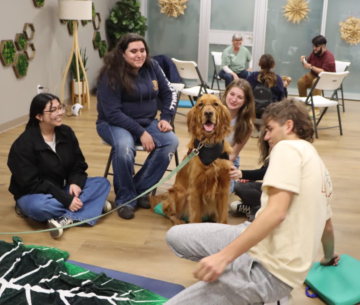 Tommy, a 3 year old Golden Retriever, interacts with students at The Well. Taken by Toby Neal on Feb. 28. 