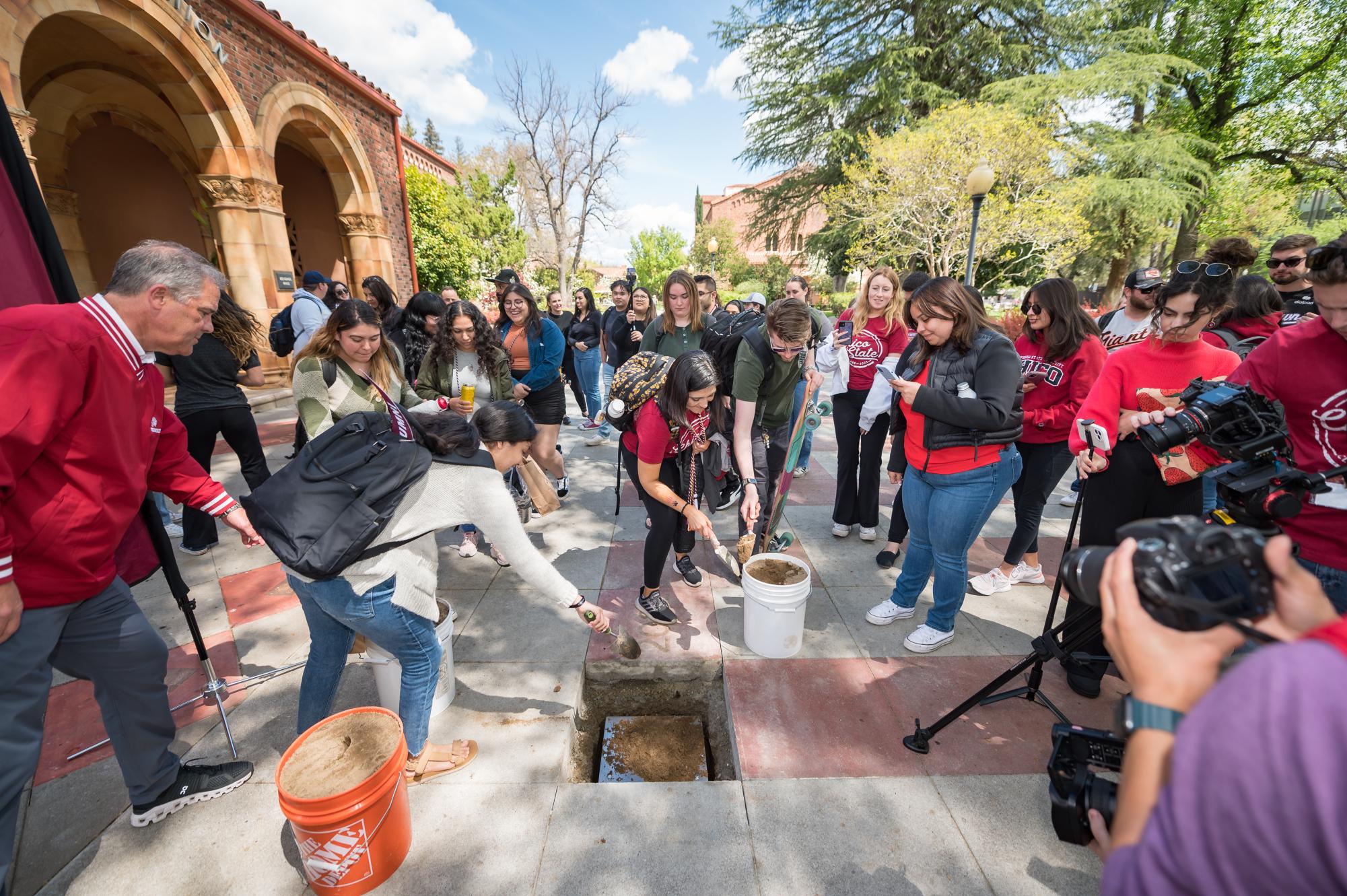 Chico State students bury the 2023 time capsule in front of Kendall Hall. Courtesy: Andrew Staples