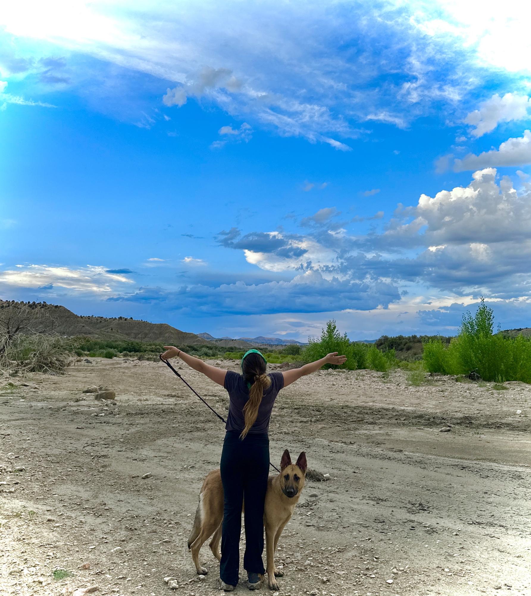 A girl and her dog enjoy the blue cloudy skies and fresh air on a walk in Cannonville, Utah, appreciating the beauty of nature and calming energy it brings. Taken by Ava Aragon on July 29, 2023.